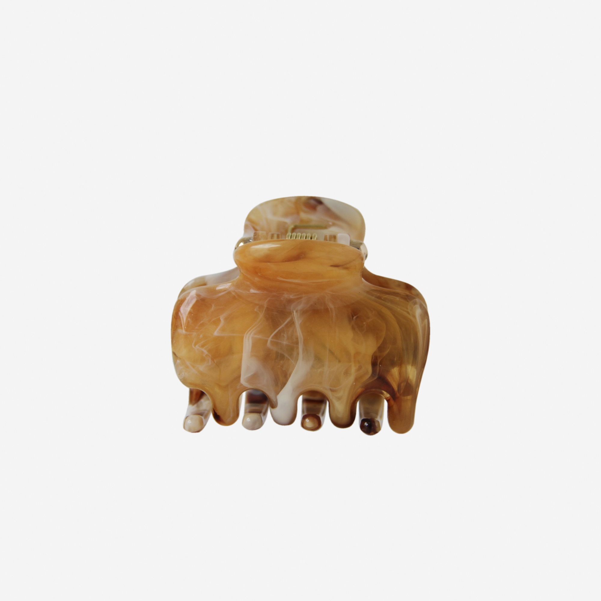The BRAID & BOW Medium Caramel Swirl Hair Claw features a marbled brown and beige design with wide teeth, shown upright against a plain white background. This versatile hair clip offers a secure hold to keep your style in place all day.