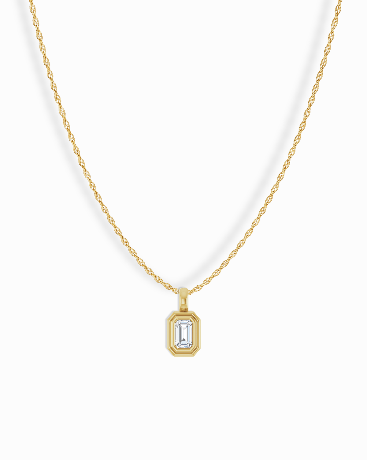 14k Birthstone Pendant Necklace featuring a gold rope chain and a rectangular pendant with a central emerald-cut clear stone.