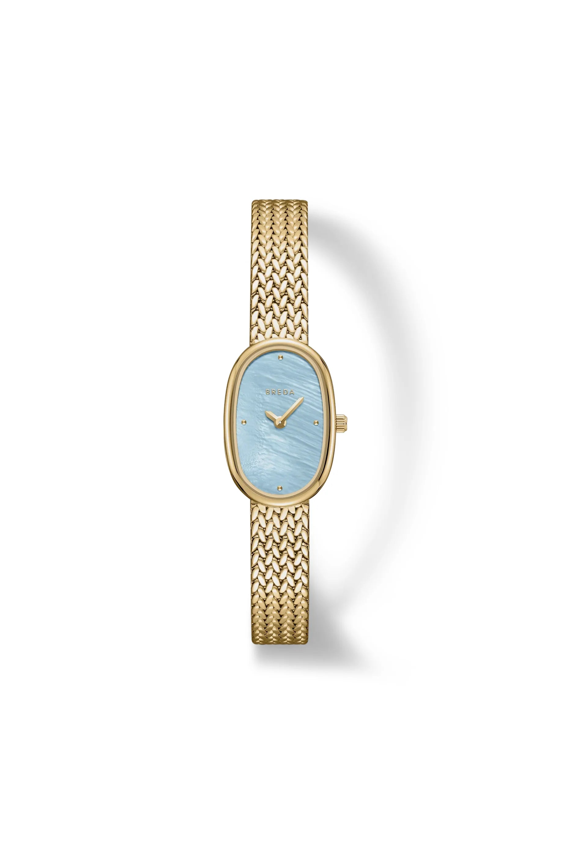 The Jane Watch Small (Tethered) by BREDA features a gold-plated design with a woven metal band and an oval light blue face, accented by small gold hour markers and hands, set against a white background.