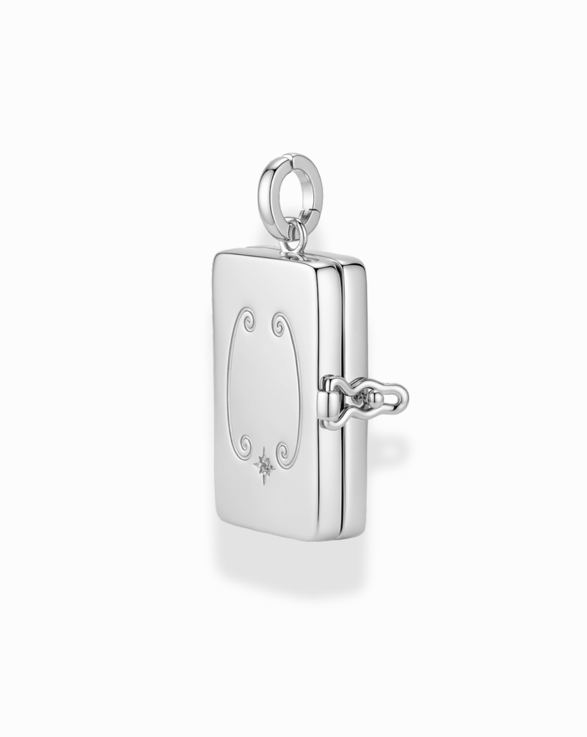 Delphine Locket Charm, a rectangular silver-plated locket with etched filigree details, a star-set stone accent, and a side hinge.