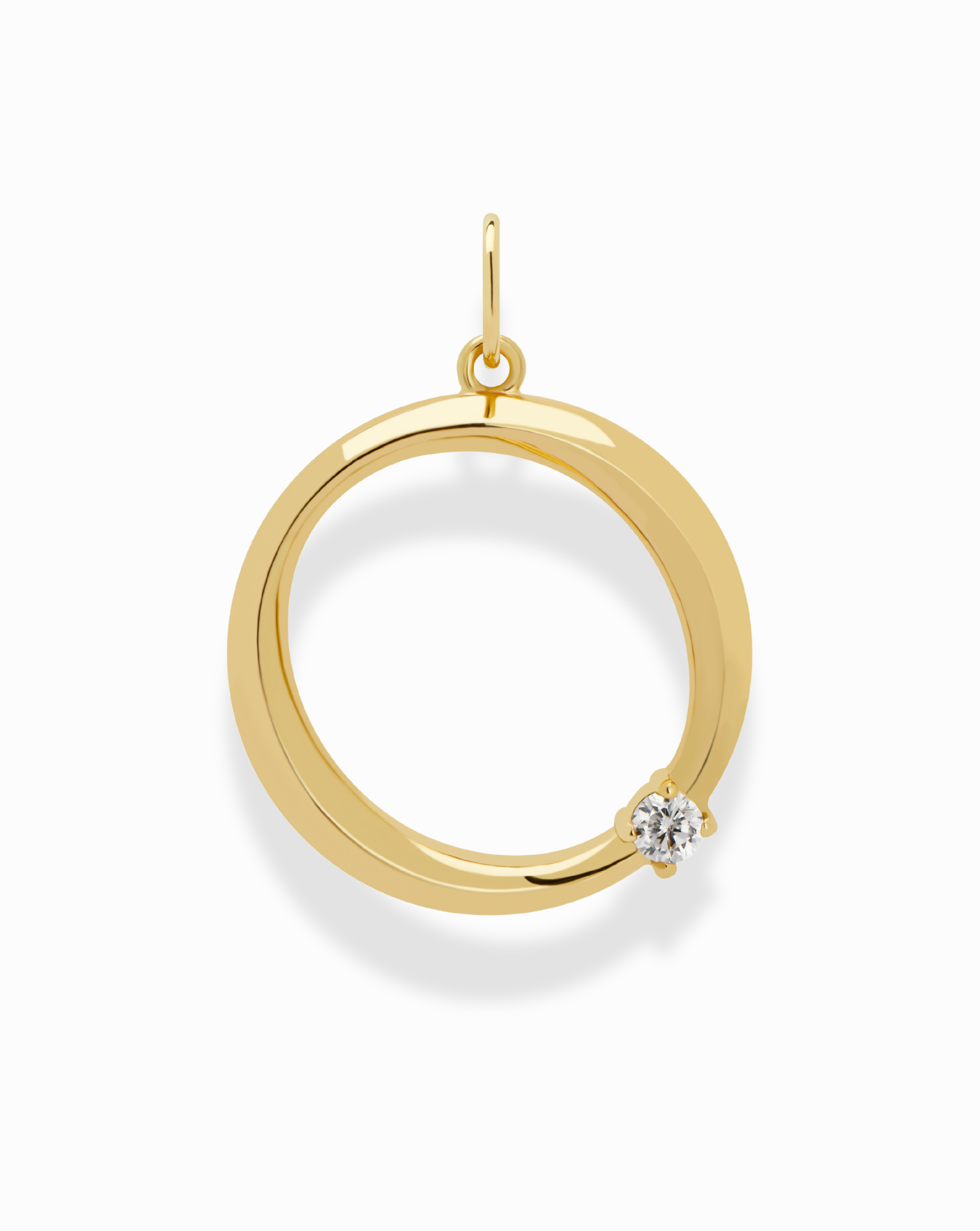 The Eloise Letter Charm by Mod + Jo is a gold circular pendant with a polished finish, featuring a round diamond near the edge and a top loop—perfect for adding personalized elegance to your necklace.