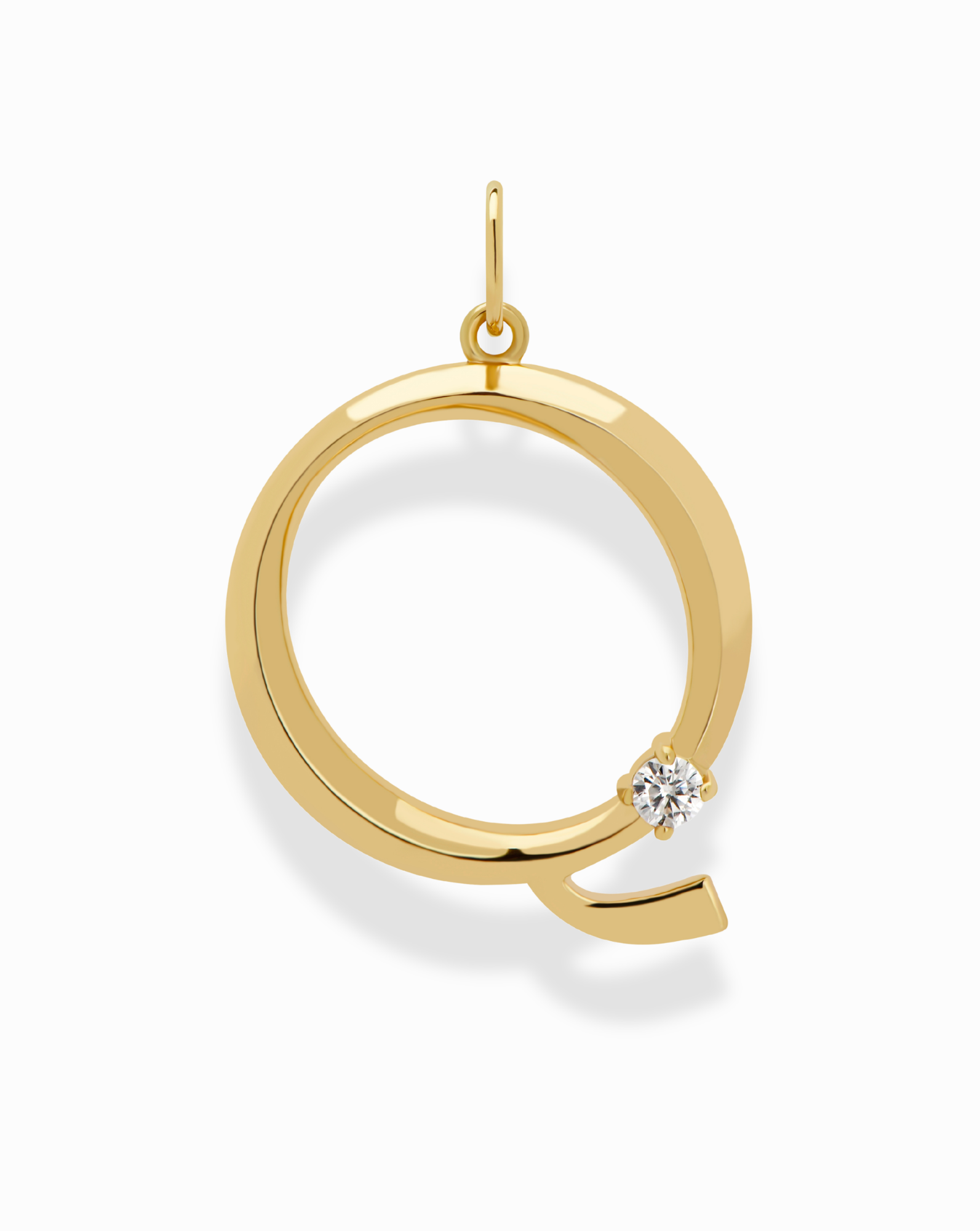 The Eloise Letter Charm by Mod + Jo is a gold pendant shaped like the letter Q, accented with a small round diamond—an elegant and personalized necklace choice.