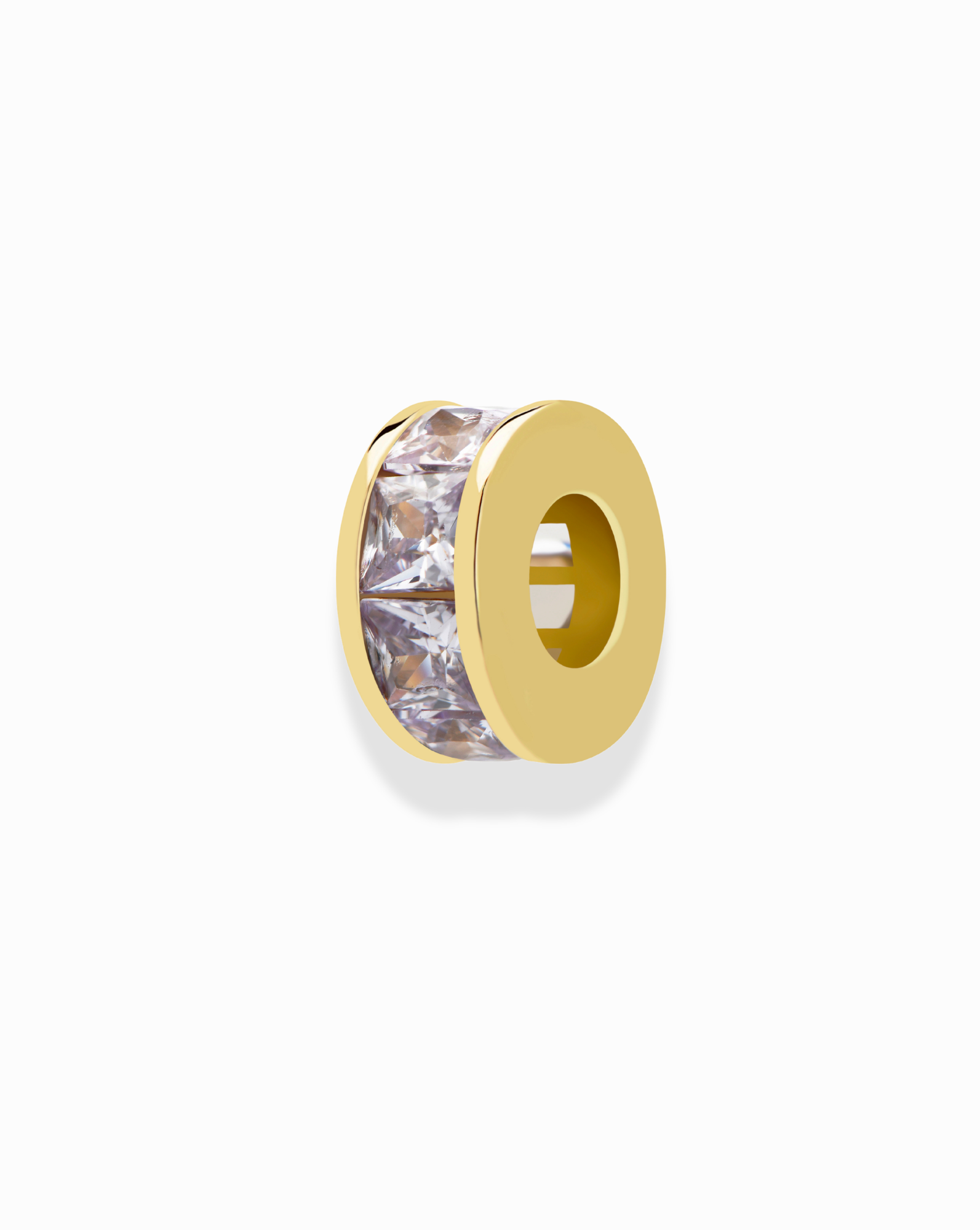 The Mod + Jo Este Birthstone Charm Spacer is a round gold bead featuring a central row of clear, square-cut gemstones set around its circumference, shown on a plain white background.