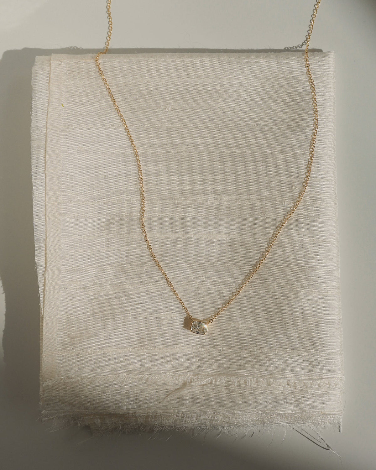 14k Cushion Cut Diamond Necklace in 14k yellow gold, featuring an adjustable chain and a single cushion-cut diamond pendant.