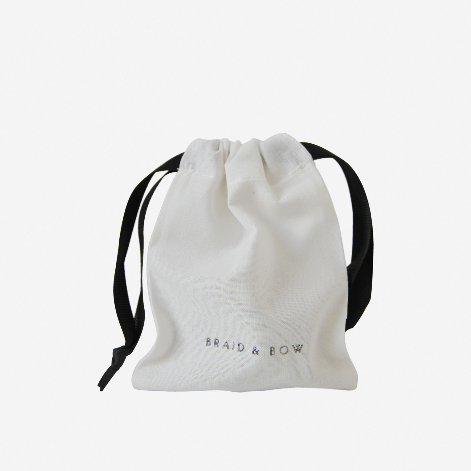 A small white drawstring pouch with black ribbons and the words BRAID & BOW printed on the front—perfect for keeping your Large Caramel Swirl Hair Claw safe and organized, while ensuring a secure hold wherever you go.