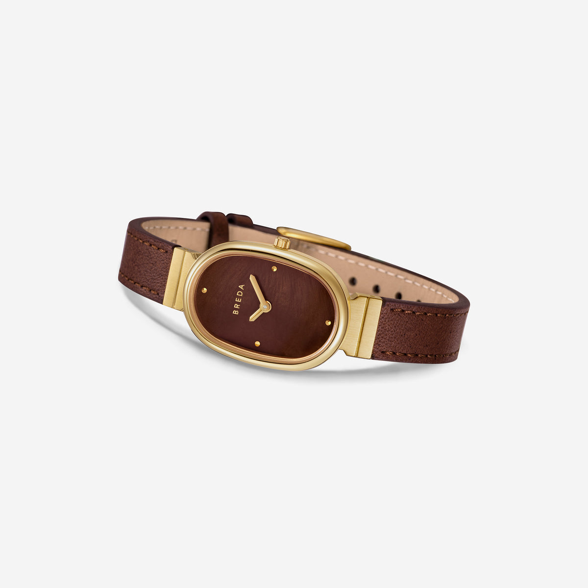 A gold-plated stainless steel oval wristwatch, BREDA Jane (Leather), featuring a brown face with the brand name “Breda” printed on it and a brown leather strap, displaying the time at 10:10.