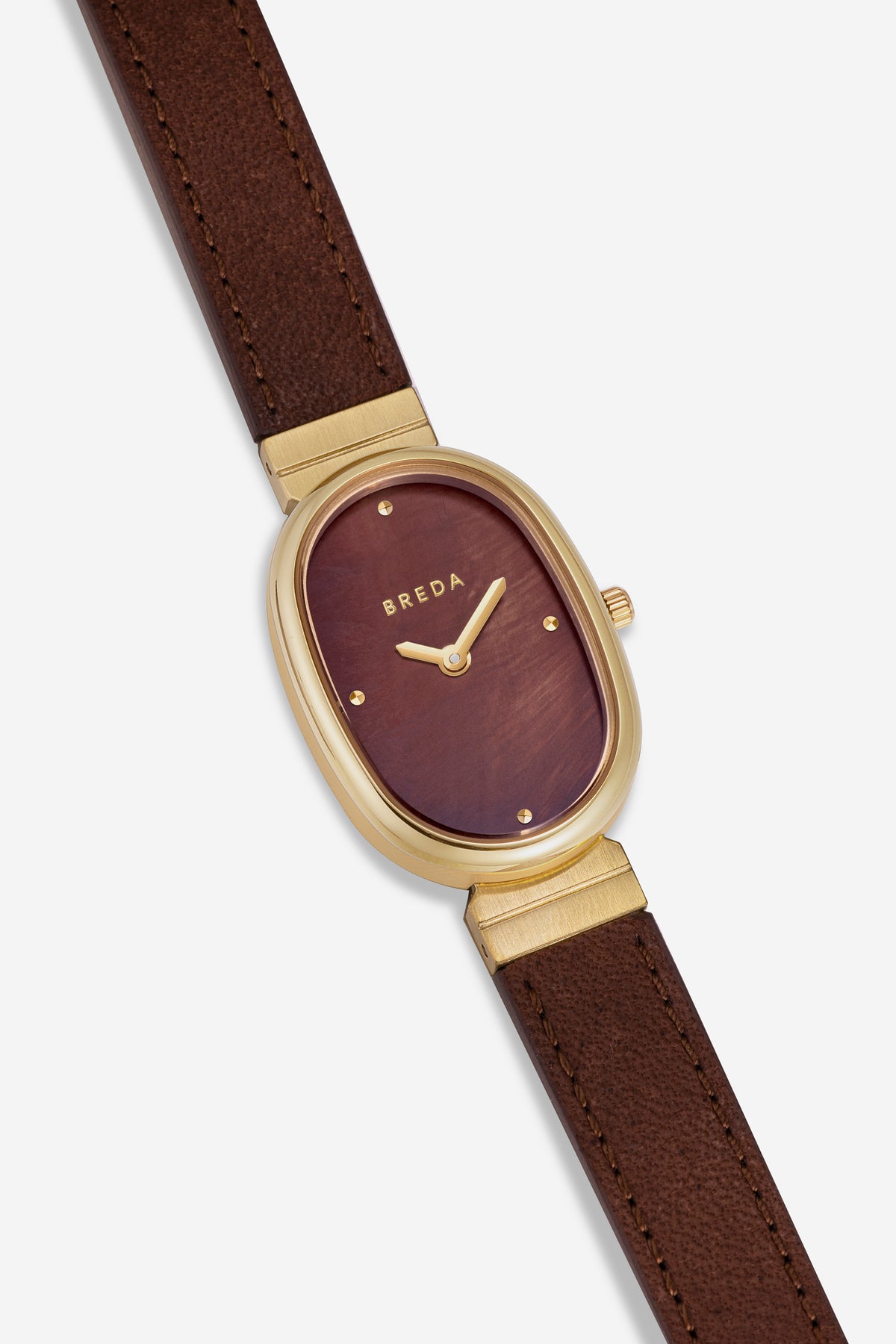 A BREDA Jane (Leather) watch featuring a gold-plated stainless steel case, a brown dial with minimalist gold hour markers, and a brown leather strap, showcased against a white background.