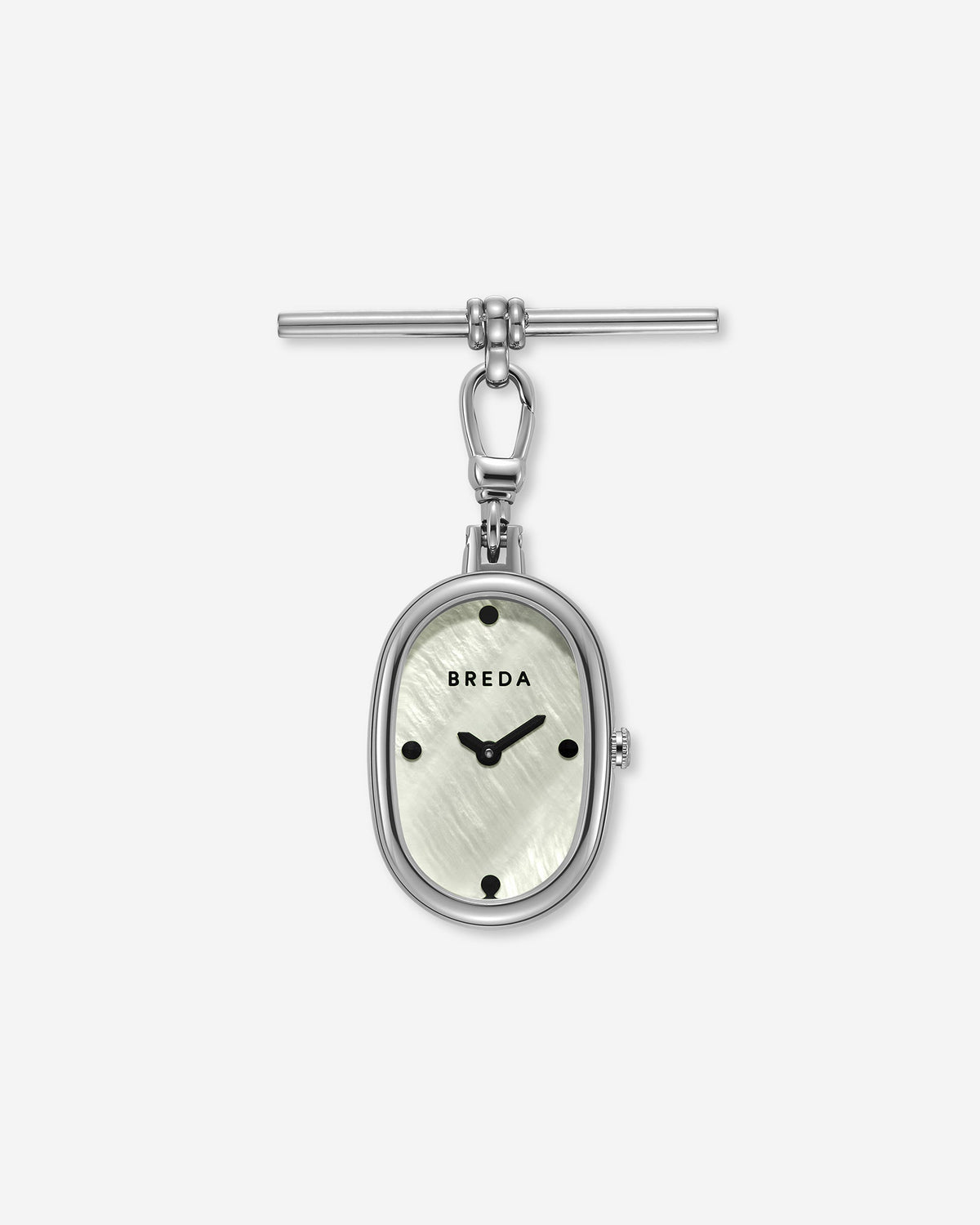 The Jane Time Charm by BREDA showcases a silver oval pocket watch featuring a white textured face, black hour markers, and Breda branding, elegantly attached to a T-bar clasp—all set against a plain white background.