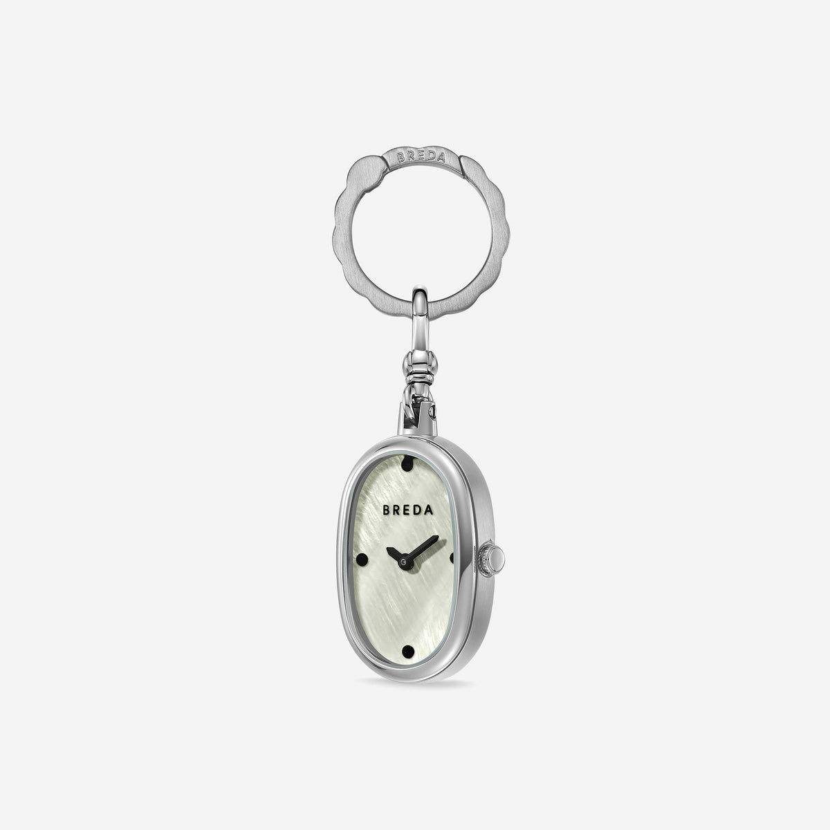 Introducing the Jane Time Charm by BREDA: an oval-shaped watch keychain featuring a silver frame, a white textured face reminiscent of mother of pearl, black hour markers, and subtle BREDA branding. Attached to a decorative silver keyring and set against a plain white background, this accessory embodies everyday elegance and versatility.