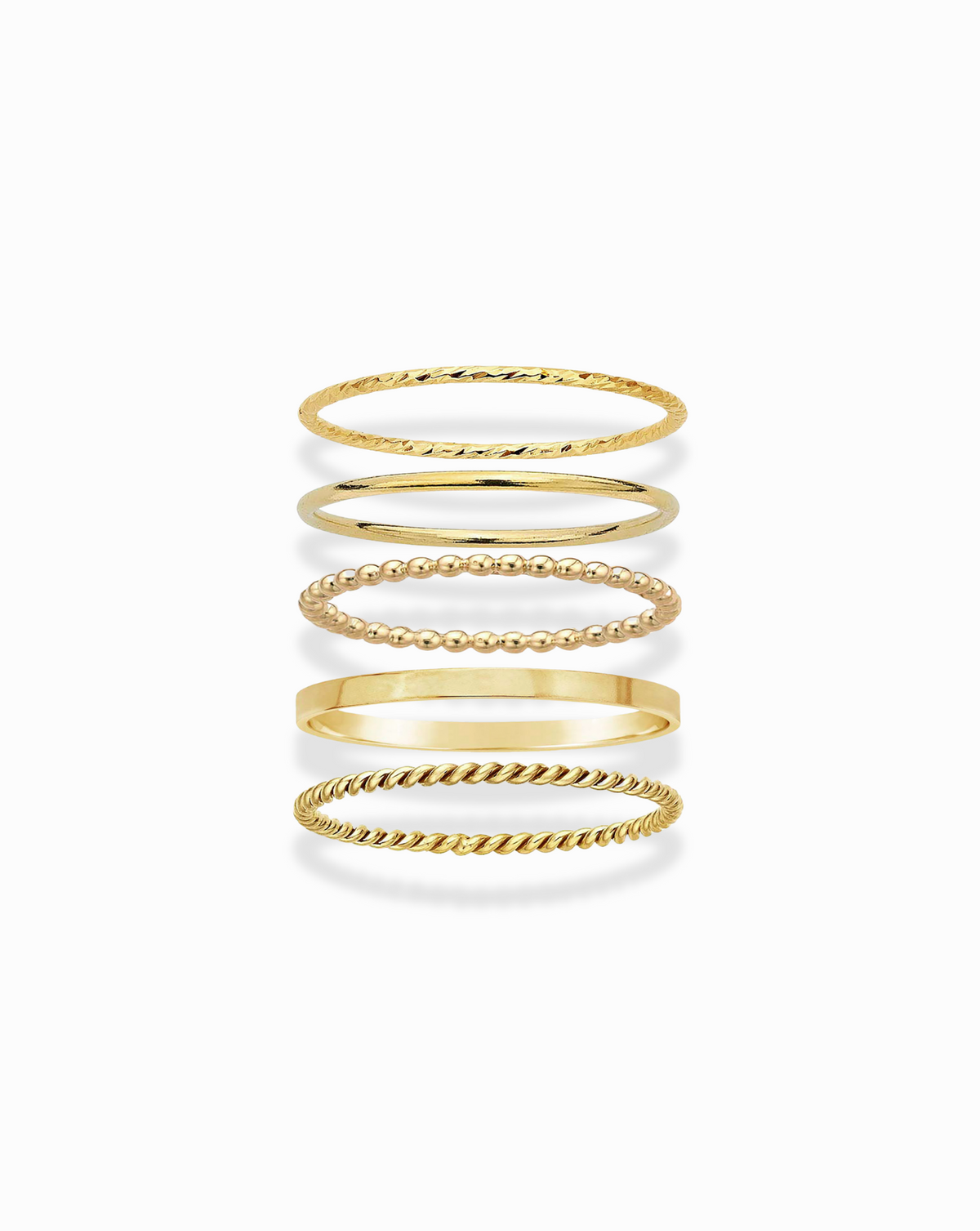 Five delicate 14k gold-filled Everyday Stacking Ring Set rings with varying textures including beaded, twisted, and smooth bands.