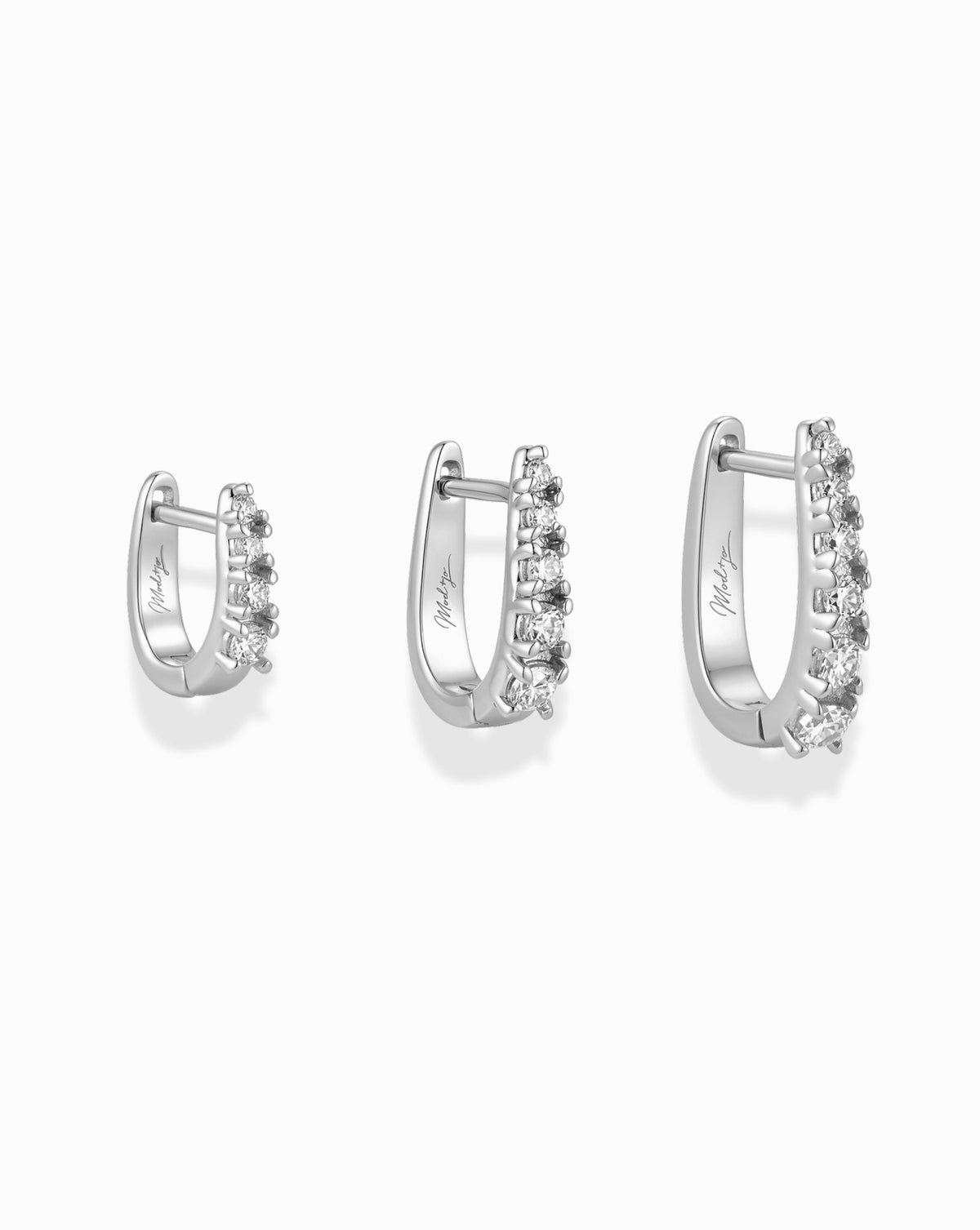The Jules Huggies Gift Set features three silver hoop earrings of graduated sizes, each with a row of small clear stones.