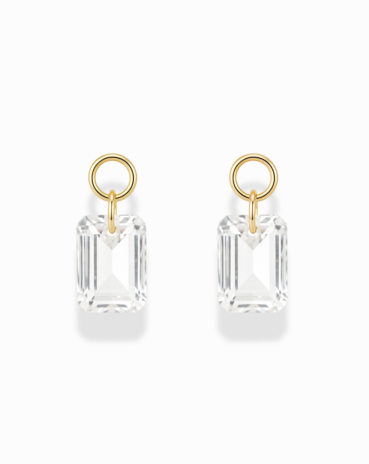 Mod + Jo Kit Sapphire Earring Charms featuring two rectangular, emerald-cut white sapphire charms hanging from gold-plated circular hoops.