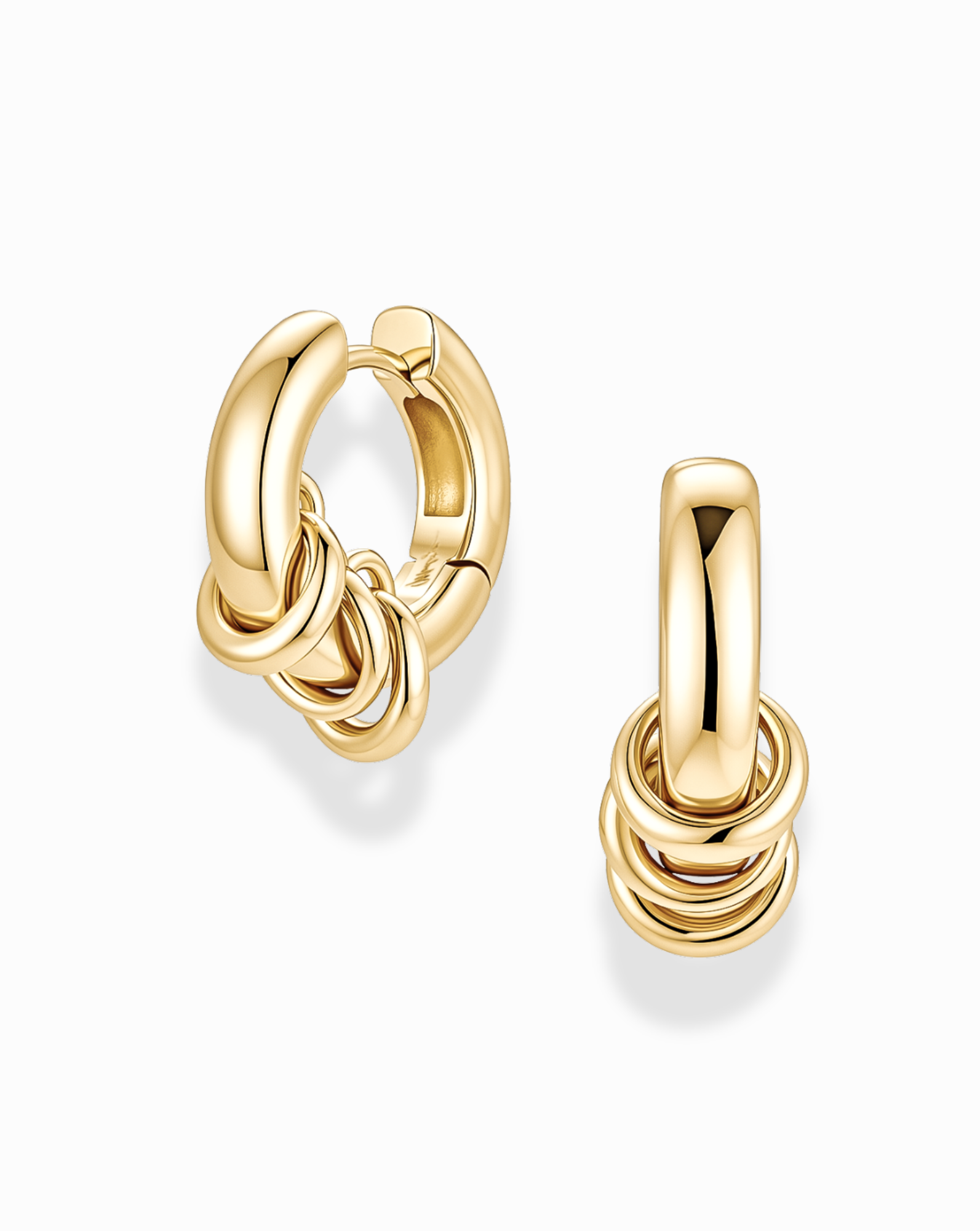 The Mod + Jo Grande Levi Huggies are small gold earrings with multiple interlocking ring details at the bottom, shown here against a white background.