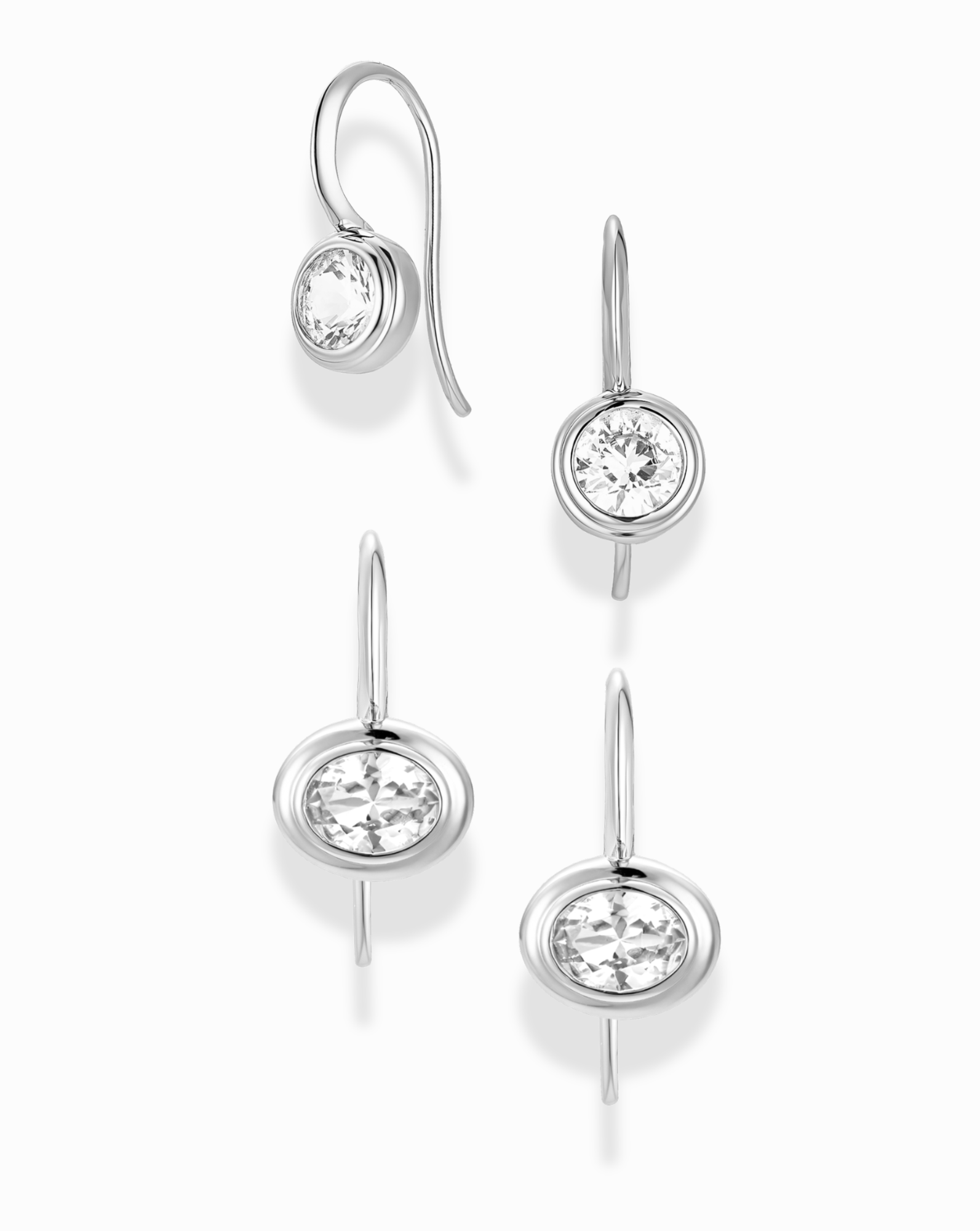 The Mod + Jo French Hook Earring Set features rhodium-plated earrings with bezel-set lab-grown white sapphires, displayed on a white background to highlight their simple, elegant design from various angles.