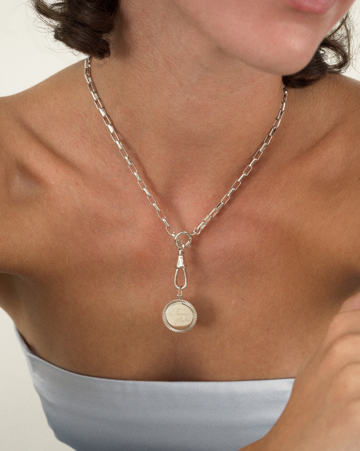 A silver Gia Engravable Charm necklace featuring a coin-edge disc pendant with a beaded bail and looped clasp.