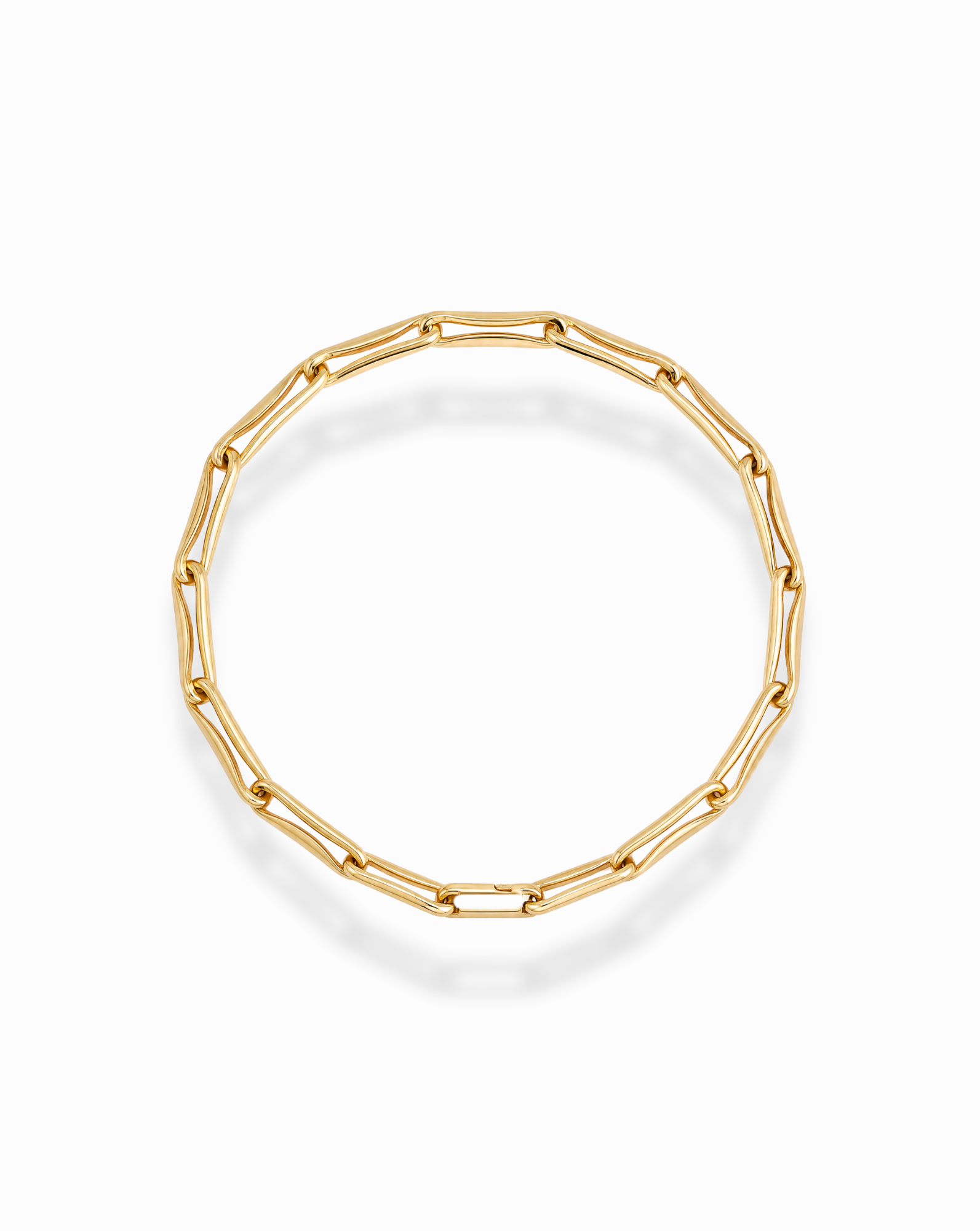 The Molly Elongated Link Chain Bracelet by Mod + Jo showcases elongated, oval-shaped gold links arranged in a circular design and displayed on a white background. This elegant bracelet elevates any layered look with its sophisticated style.