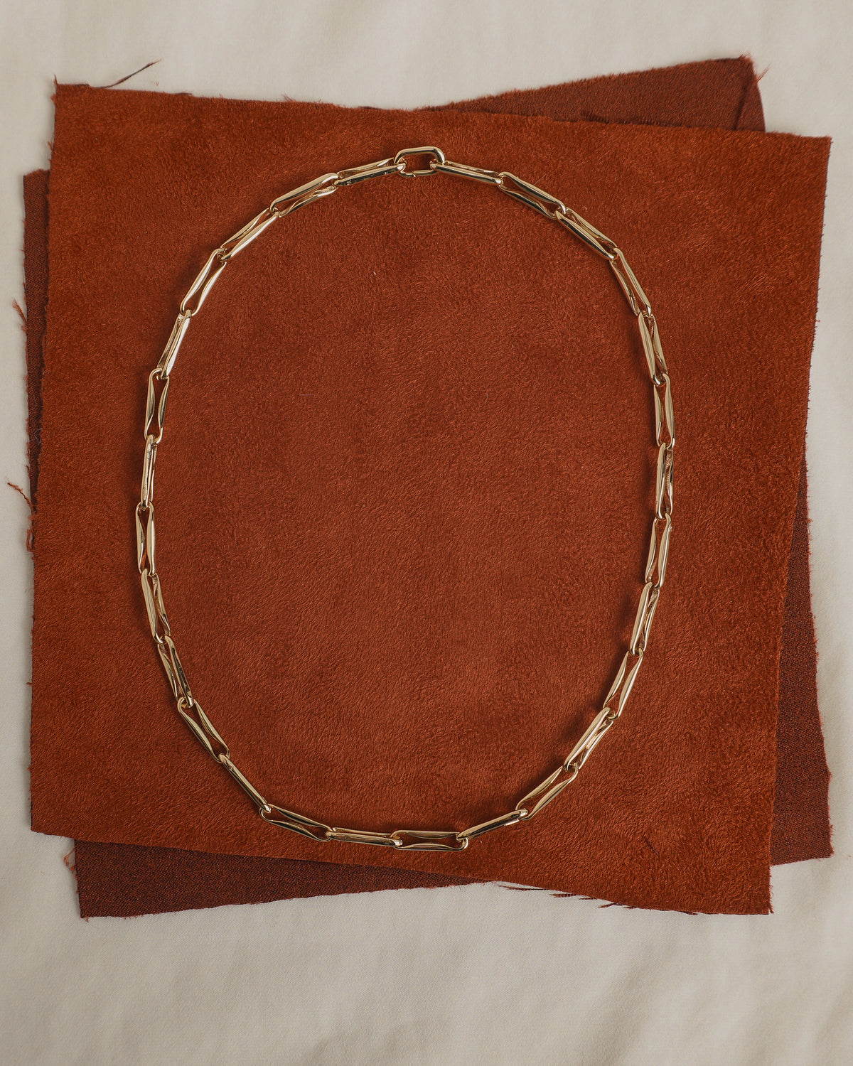 Molly Elongated Link Chain Necklace in a gold-toned finish featuring elongated rectangular links laid in an oval shape.