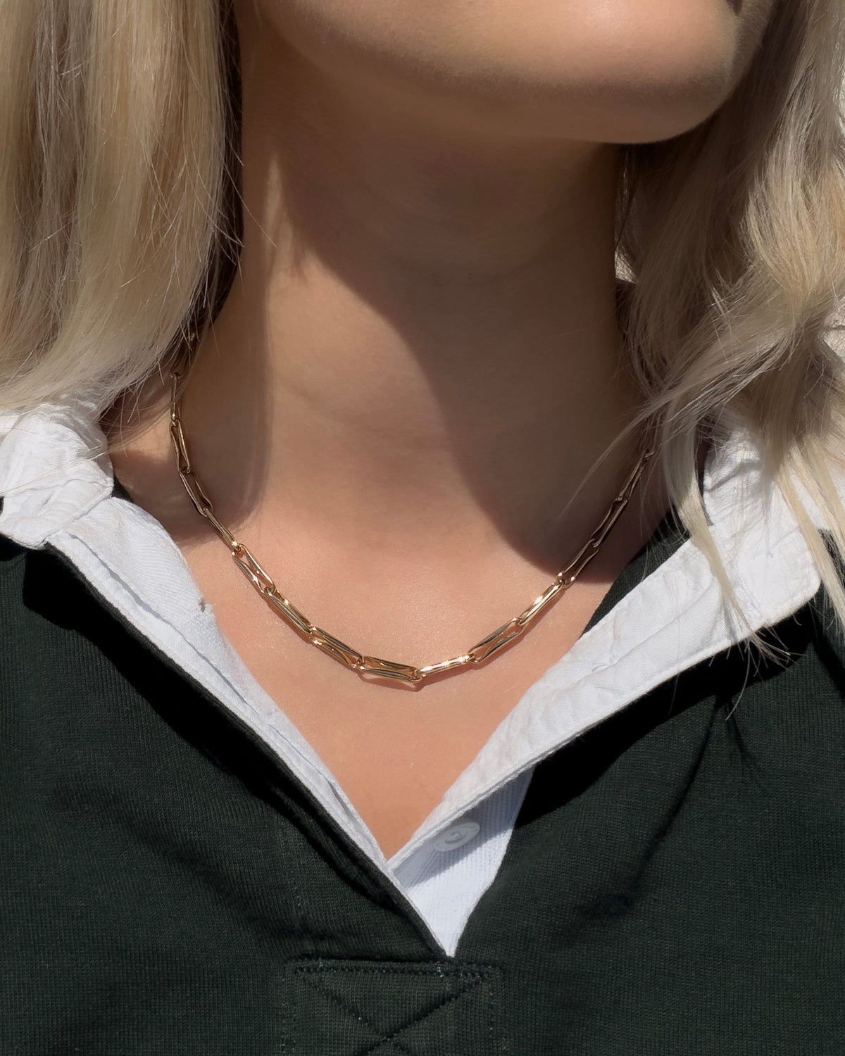 Molly Elongated Link Chain Necklace in gold, worn around the neck.