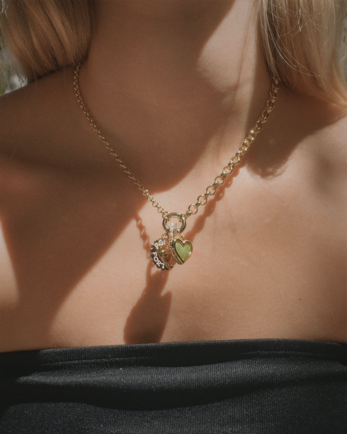 Mod + Jo Nessa Charm Clip Necklace featuring a 14k gold round hinged clasp with dangling heart and circular charms.