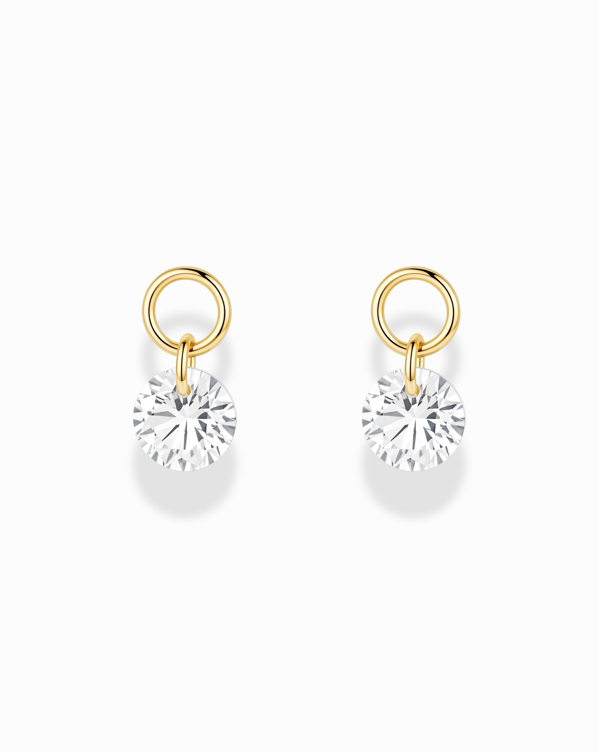 Noa Sapphire Earring Charms consisting of two round gold-plated charms featuring dangling circular lab-grown white sapphires.