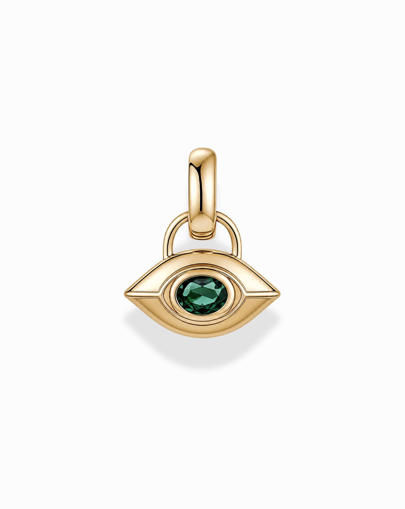 The Mod + Jo Nyx Evil Eye Charm is a gold, eye-shaped pendant featuring a green gemstone at its center, designed with a smooth finish and an attachment loop, shown against a white background.