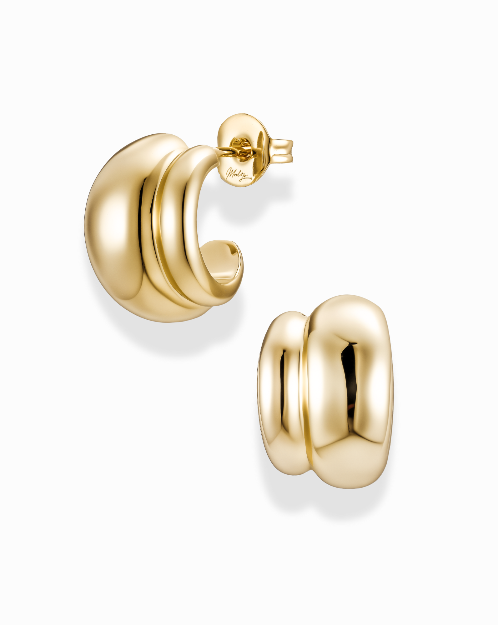 Gold double dome hoop earrings on a white background