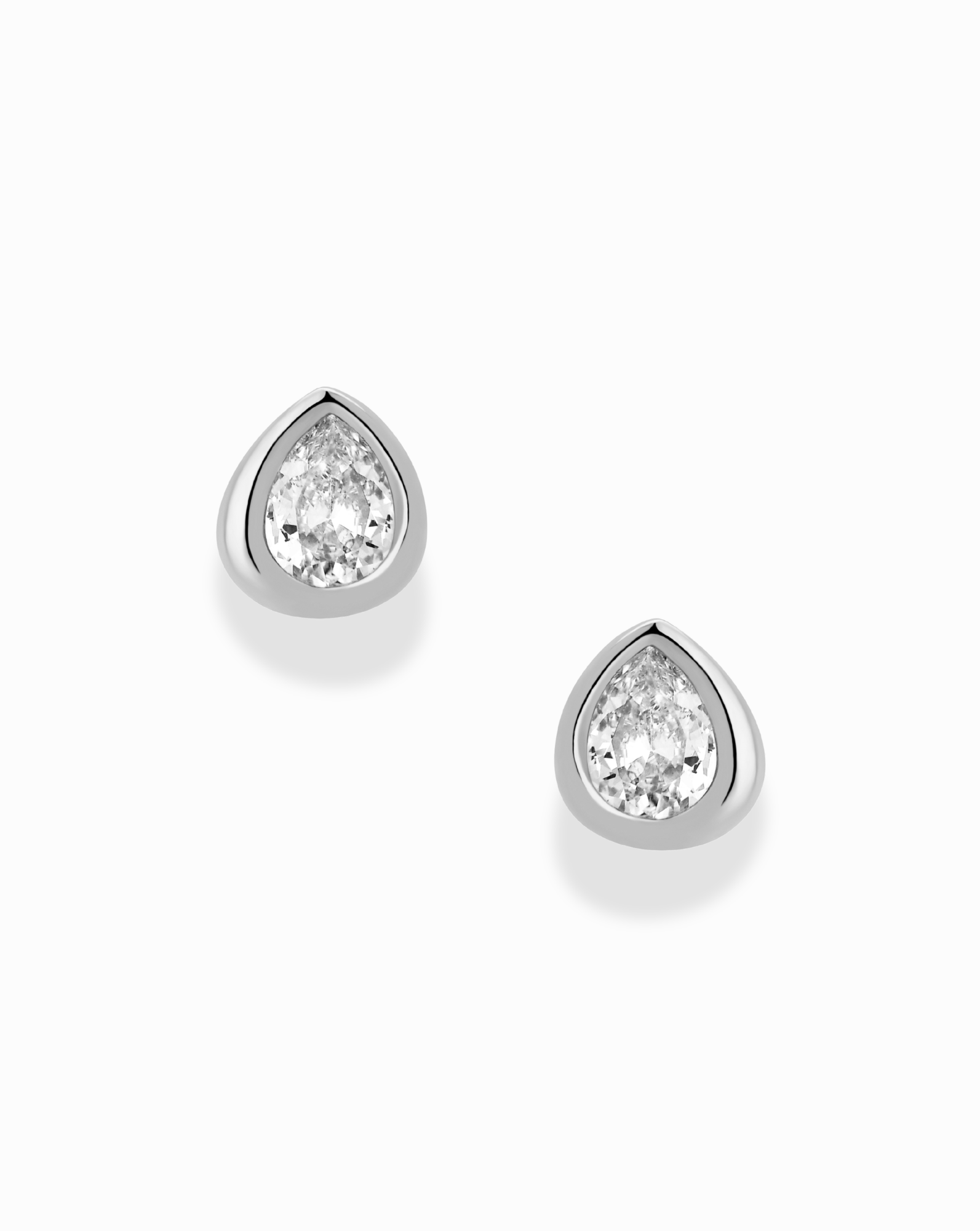 Joni Bezel Studs by Mod + Jo—pear-shaped diamond bezel stud earrings set in silver or white gold, shown on a plain white background.