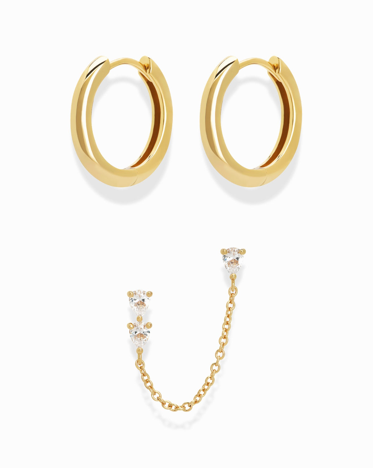 The Reneé + Tatum Set featuring a pair of polished gold hoops and a single gold chain earring with two cubic zirconia studs connected by a fine chain.