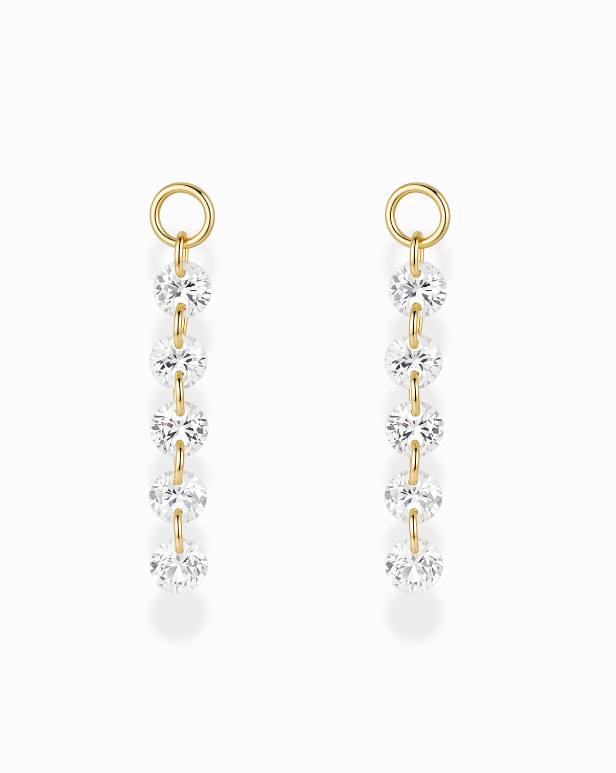 Two gold-plated Sade Sapphire Earring Charms, each featuring a vertical line of five round, faceted lab-grown white sapphires in a floating setting hanging from a circular hoop.