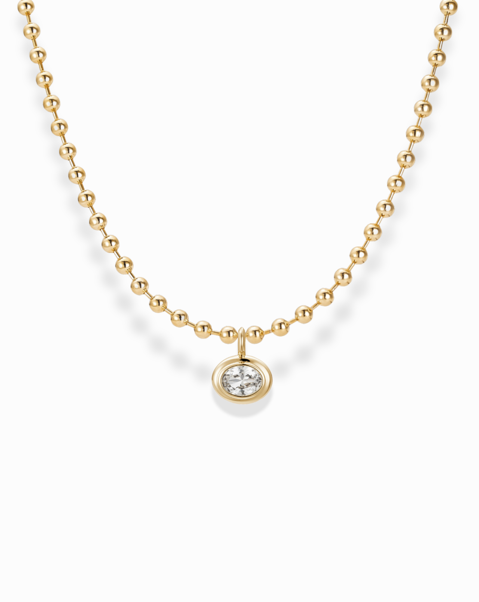 The Soren Bezel Pendant Necklace is a nickel-free, 14k gold plated beaded chain with a round lab-grown white sapphire pendant, shown against a white background.