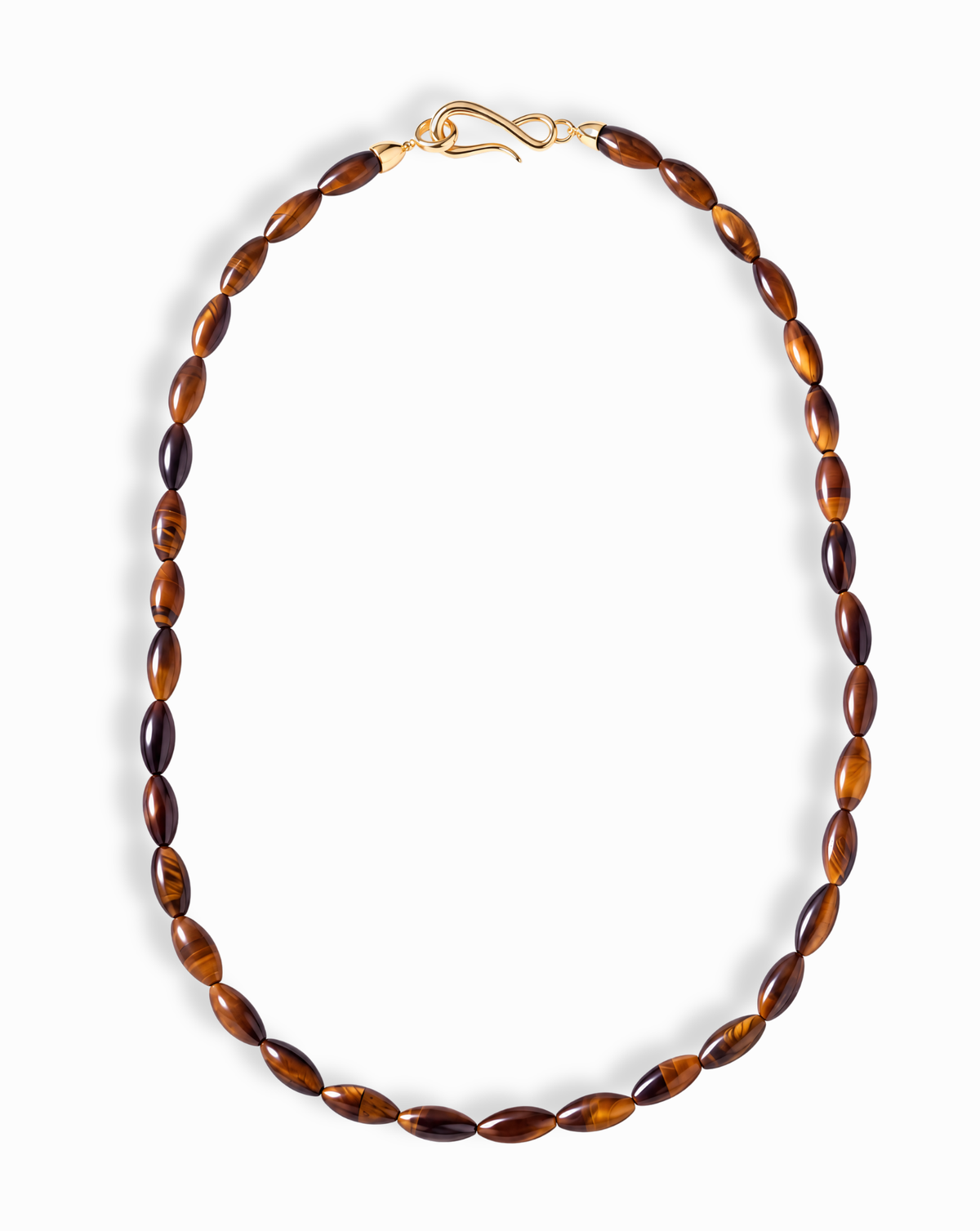 Sutton Gemstone Necklace featuring 18-inch oval, rice-shaped tiger’s eye beads with a gold S-hook clasp.