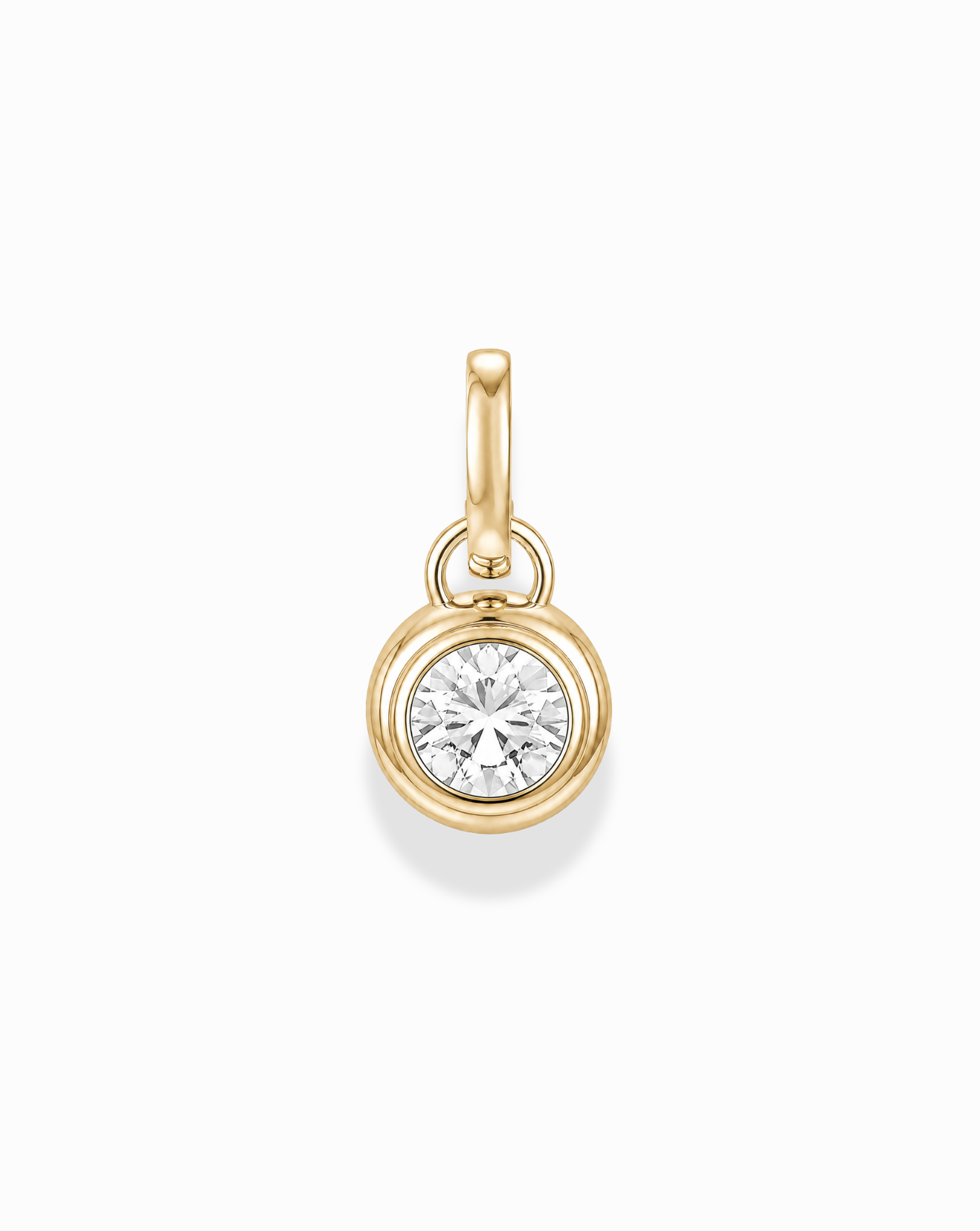 The Tove Sapphire Bezel Charm by Mod + Jo is a small 14k gold pendant featuring a round, clear lab-grown sapphire in a simple bezel setting with a gold loop, shown on a white background.